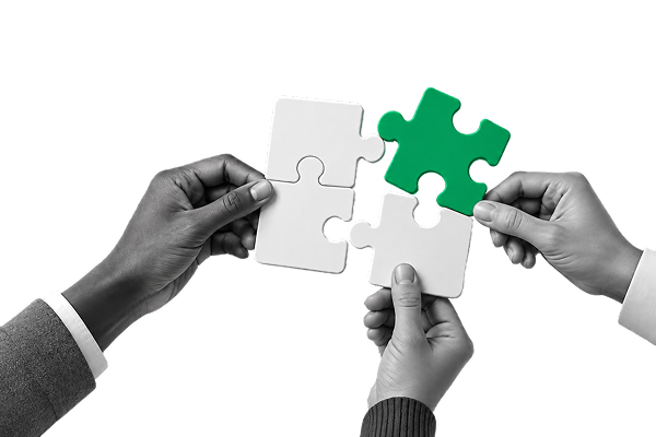Hands joining puzzle pieces together
