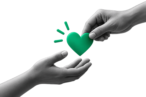 One hand passing a green heart to another