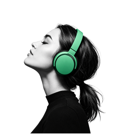 a woman listening to music on green headphones